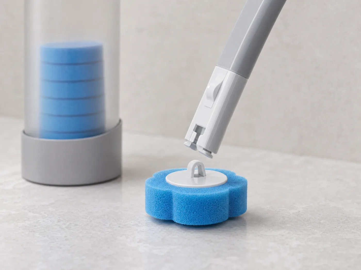 Close-up of the wand tip about to click onto a fresh scalloped foam head